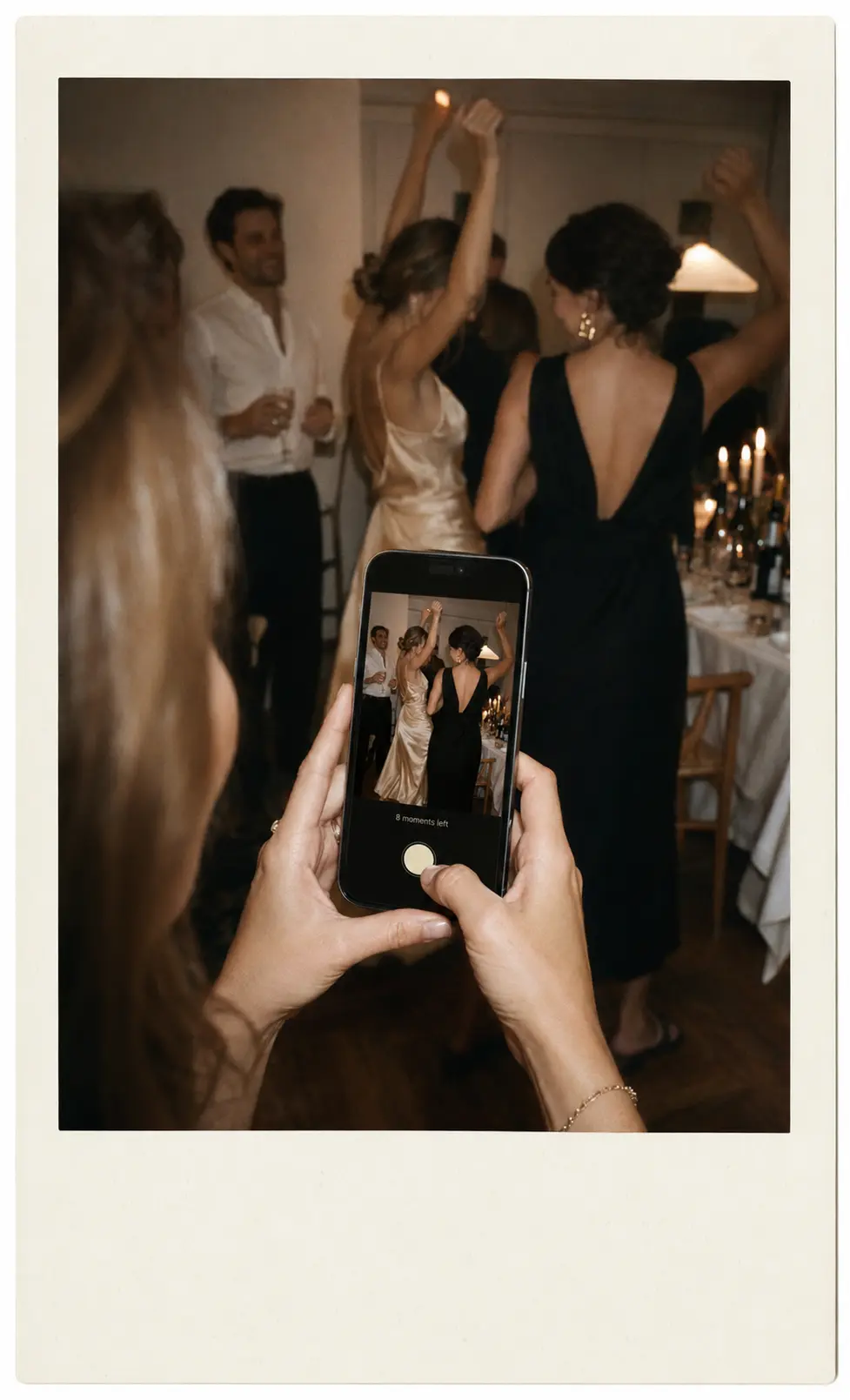 A guest using the Momenti camera to photograph friends dancing
