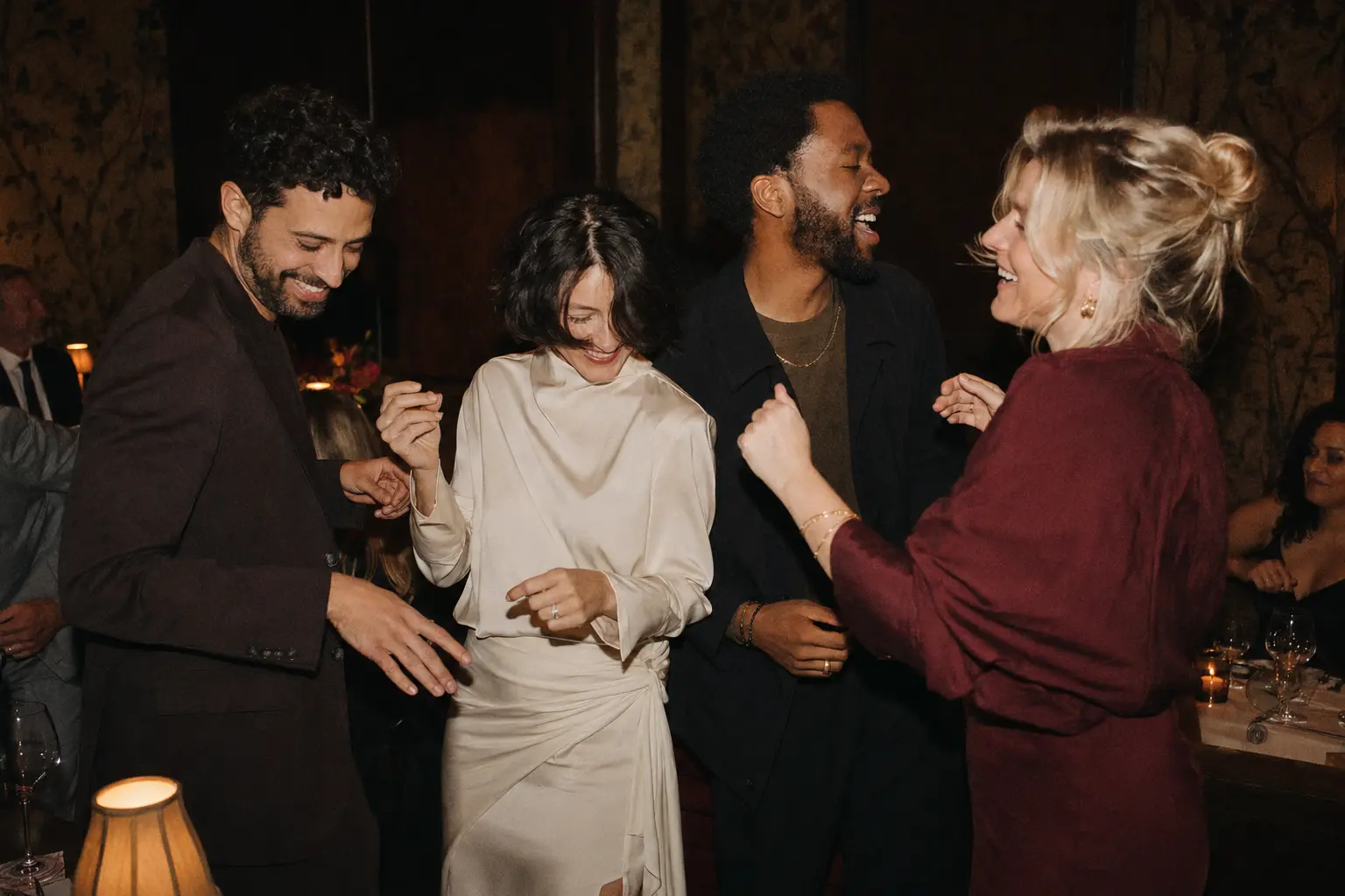 Four friends dancing after dinner