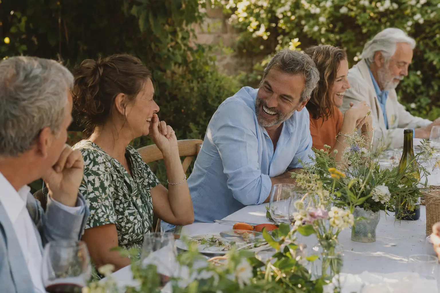 Friends sharing a long garden lunch